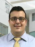 head shot young man wearing glasses in shirt and tie