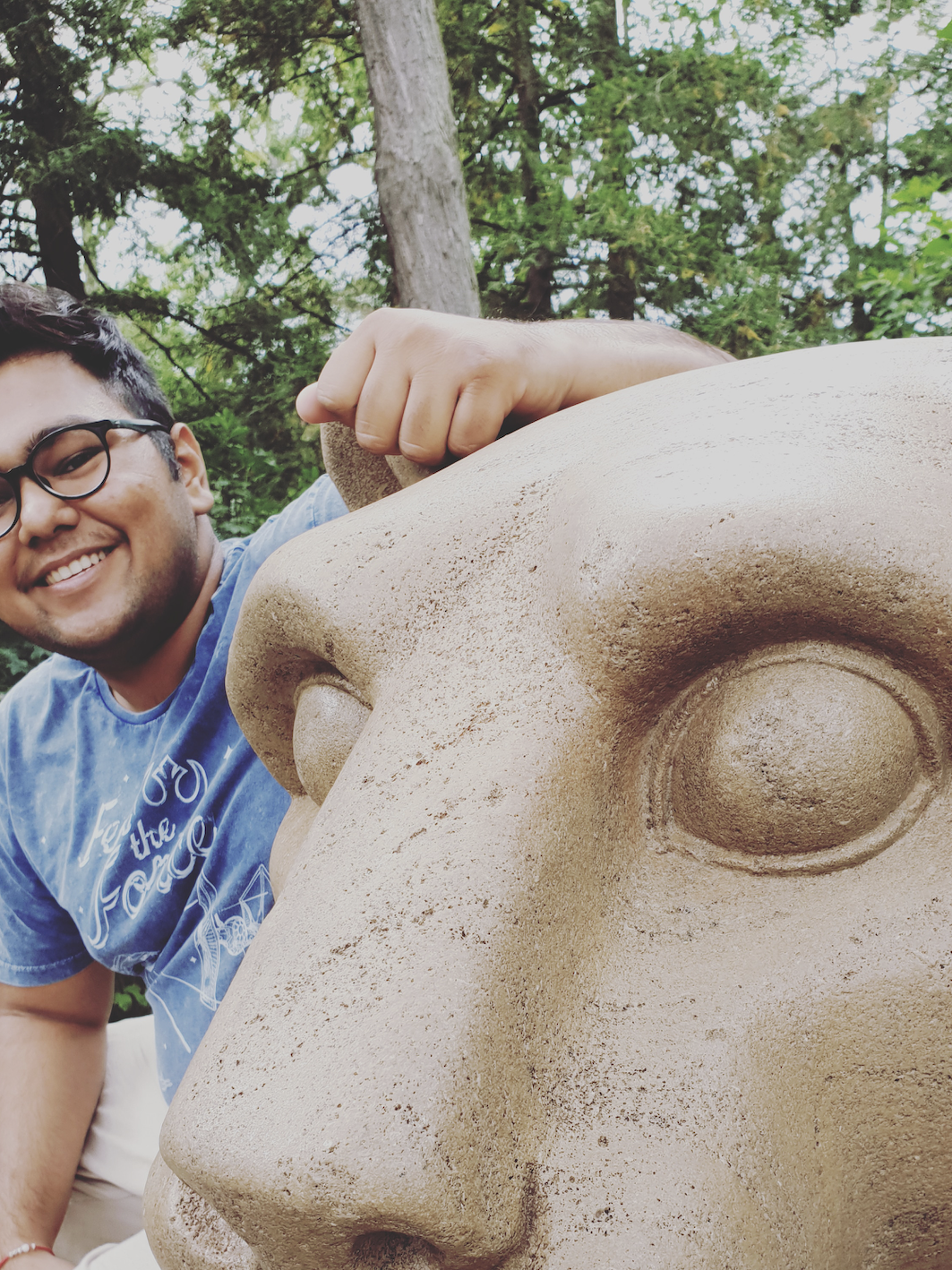 A young man smiles at the lion shrine.