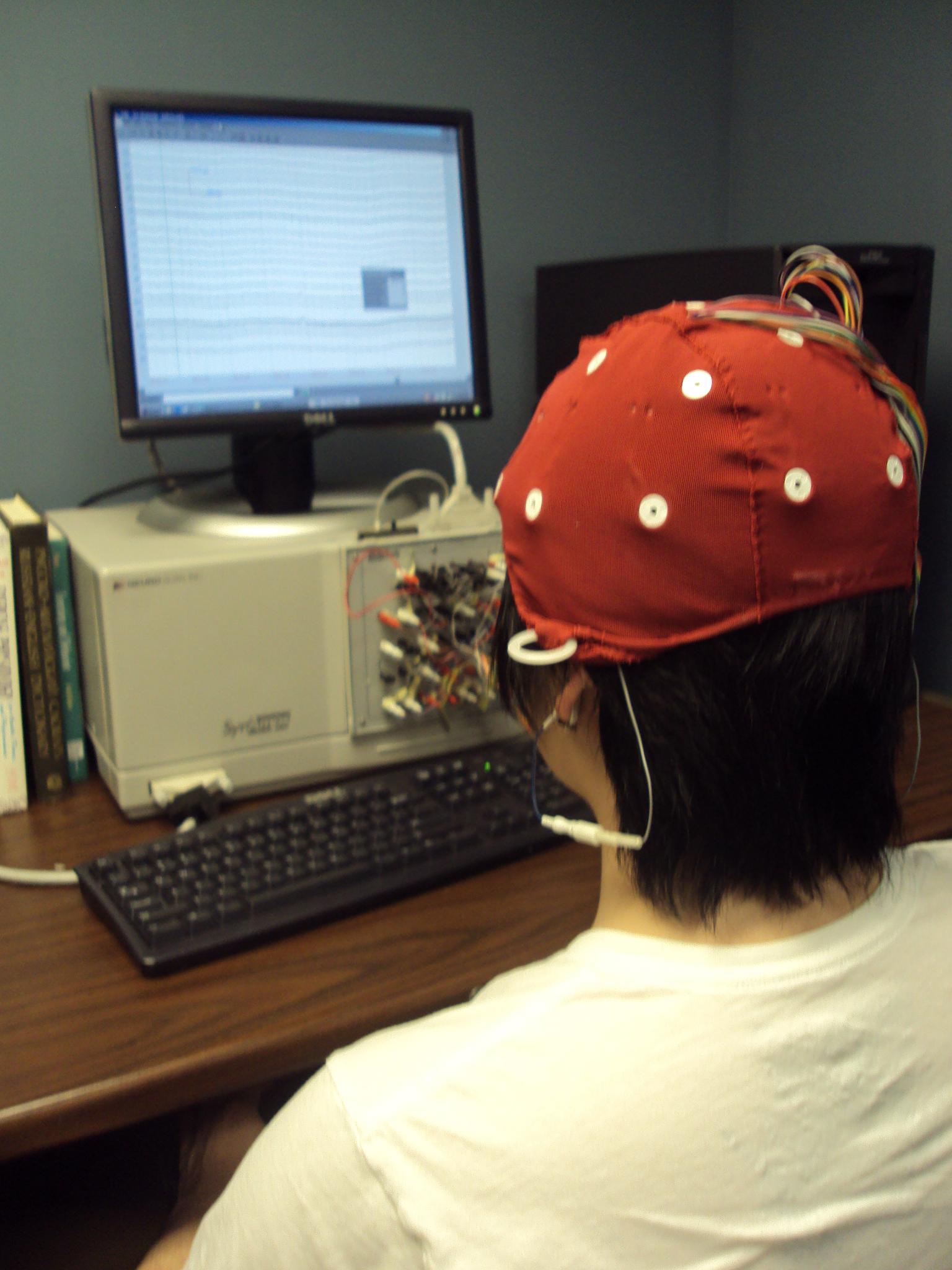 EEG during recording with cap applied and computer showing electrode readings