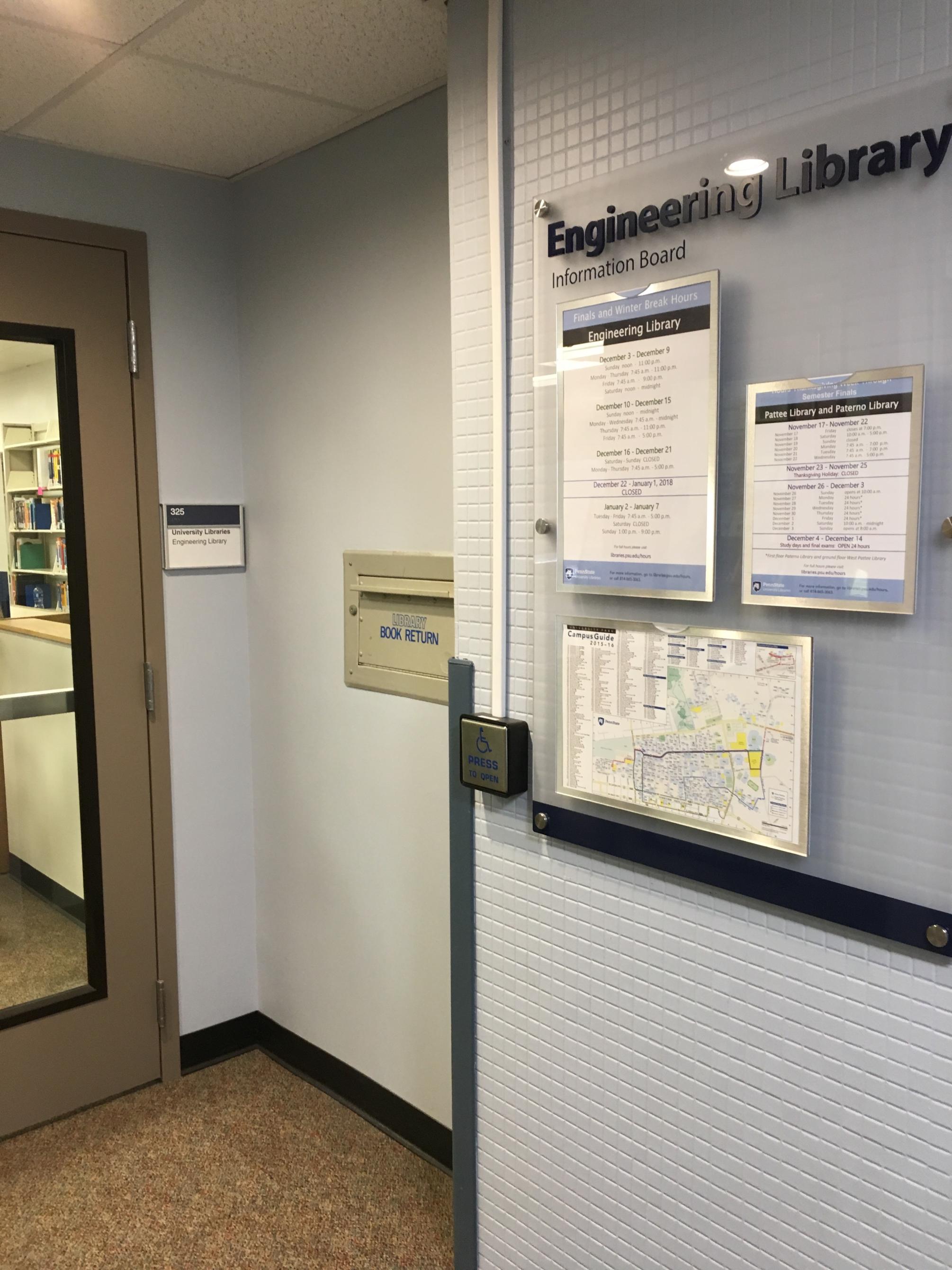 interior photo of Engineering Library entrance showing door, book return slot, glass information board