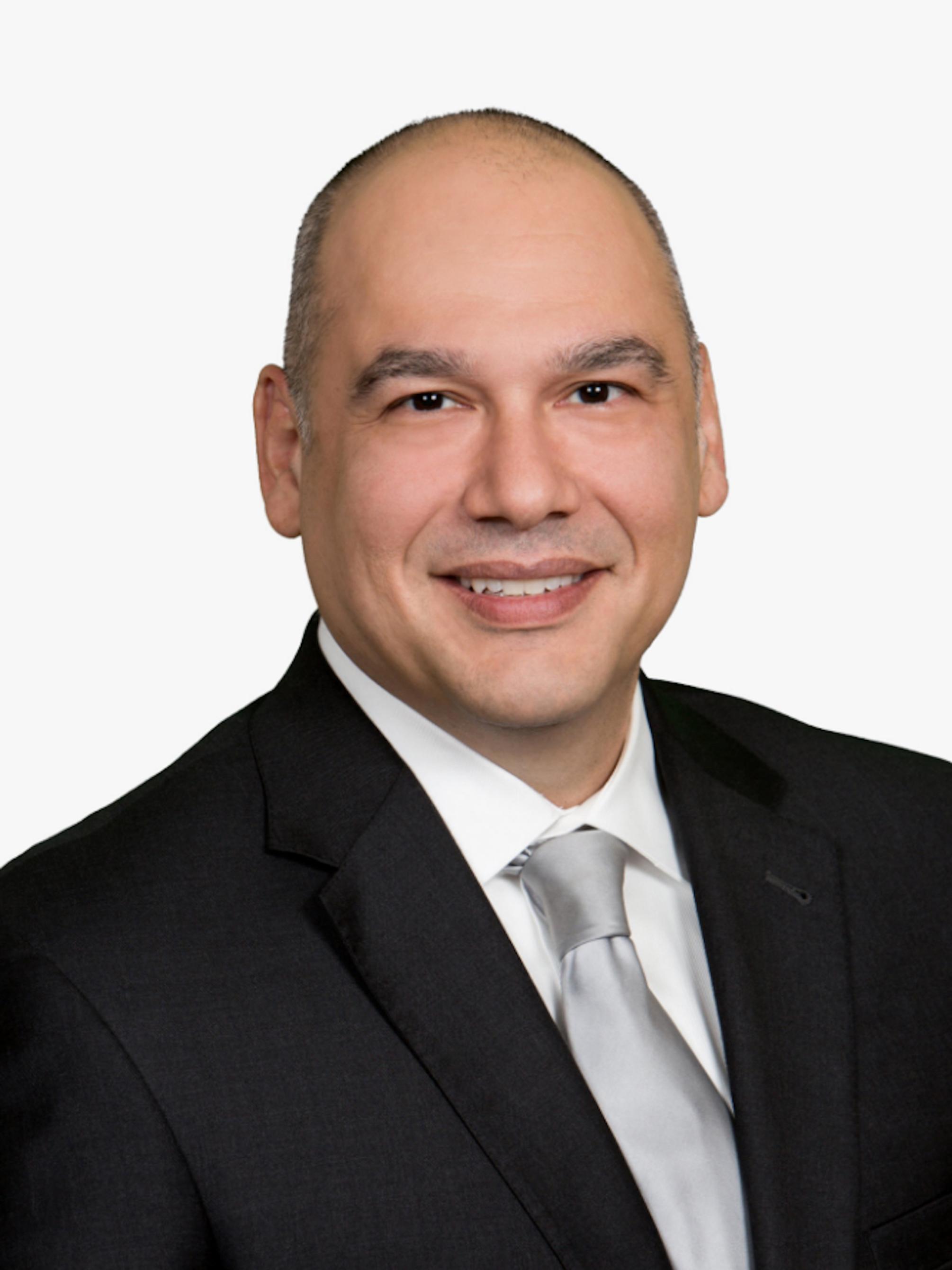 A man smiles for a photo