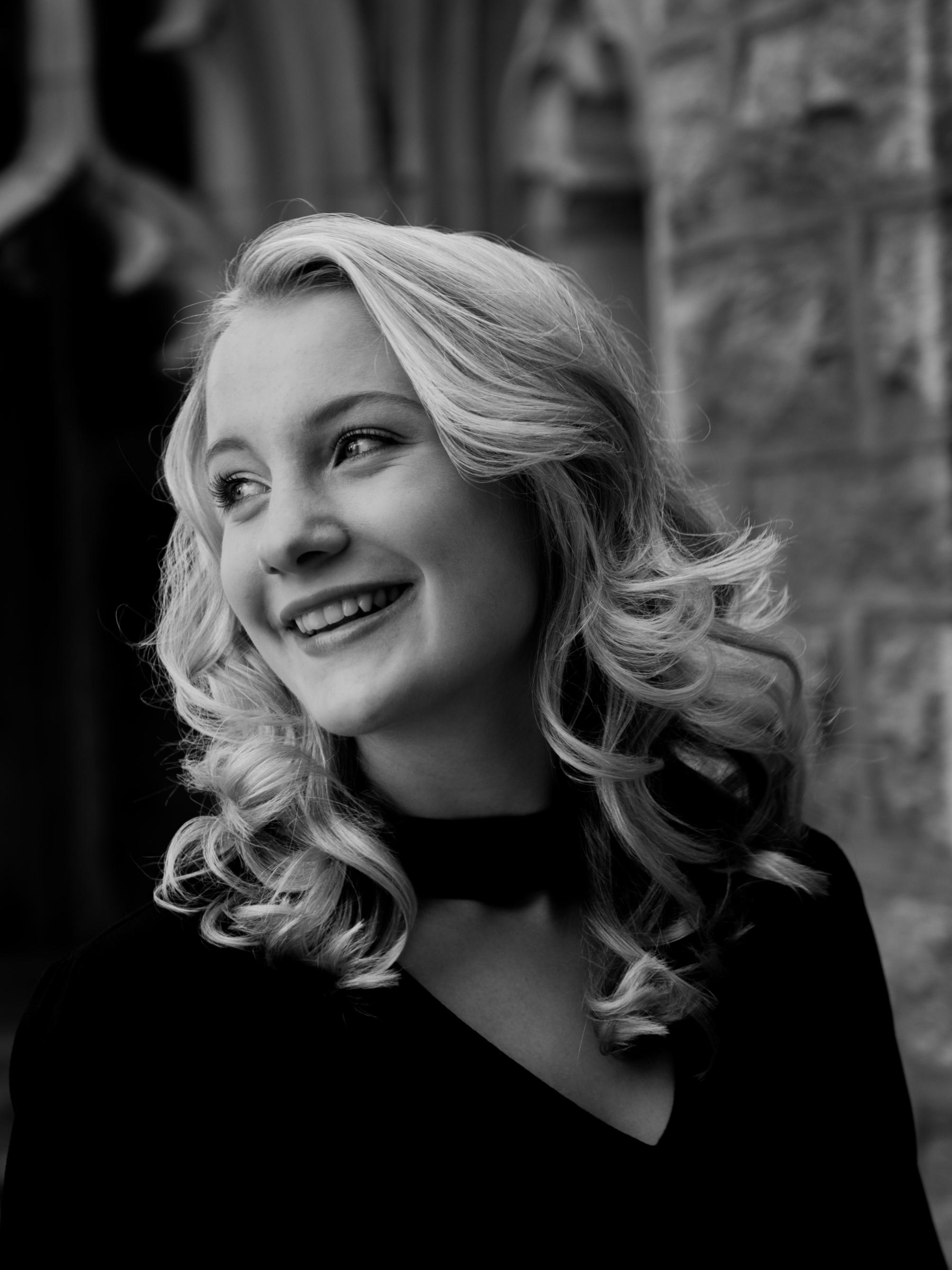 Black and white headshot of Taylor Kuszyk
