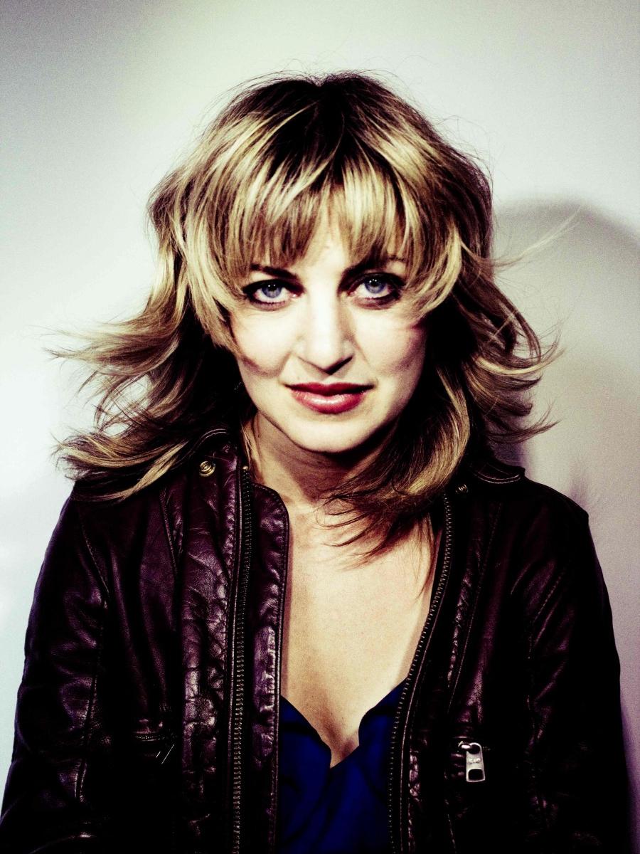 Singer-songwriter Anaïs Mitchell looks straight at the camera and with a half-smile.
