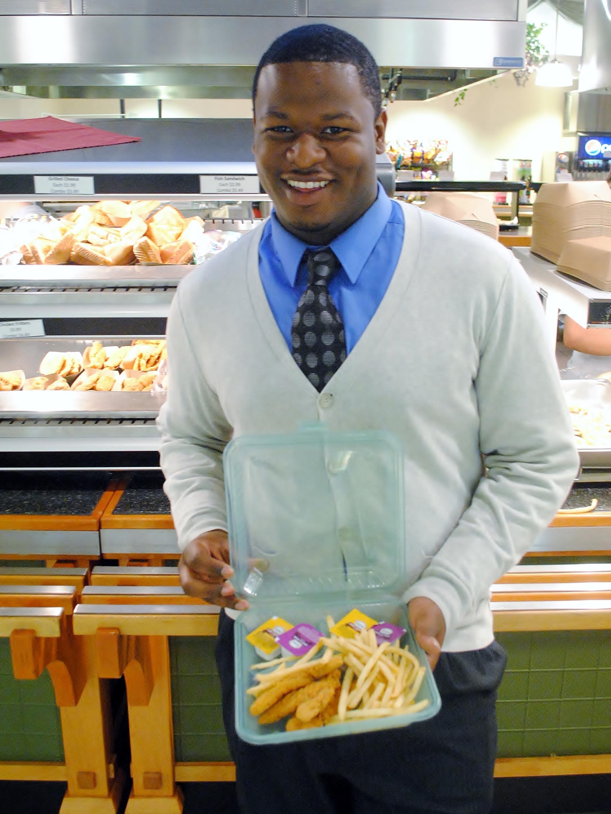 Penn State Behrend student Isaiah Boswell shows off a Green2Go container.