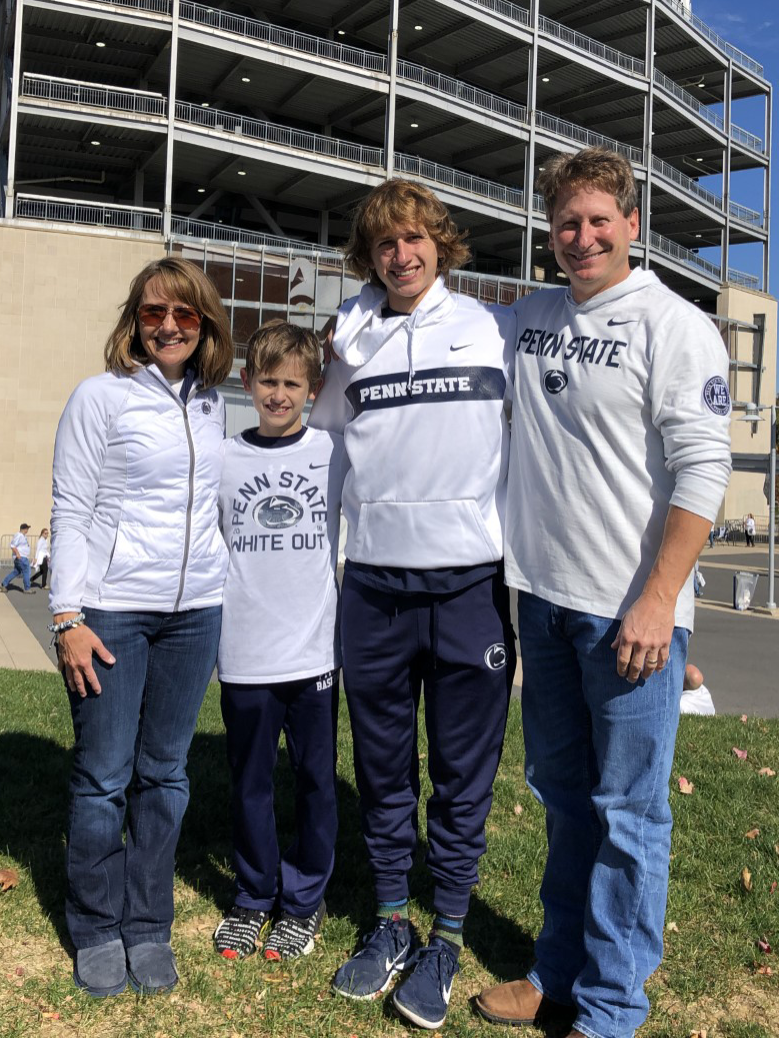 Dr. Kimberly Hashin and Albert J. "BJ" Evans, Esq. with sons Albe and Alan, at Beaver Stadium, University Park.