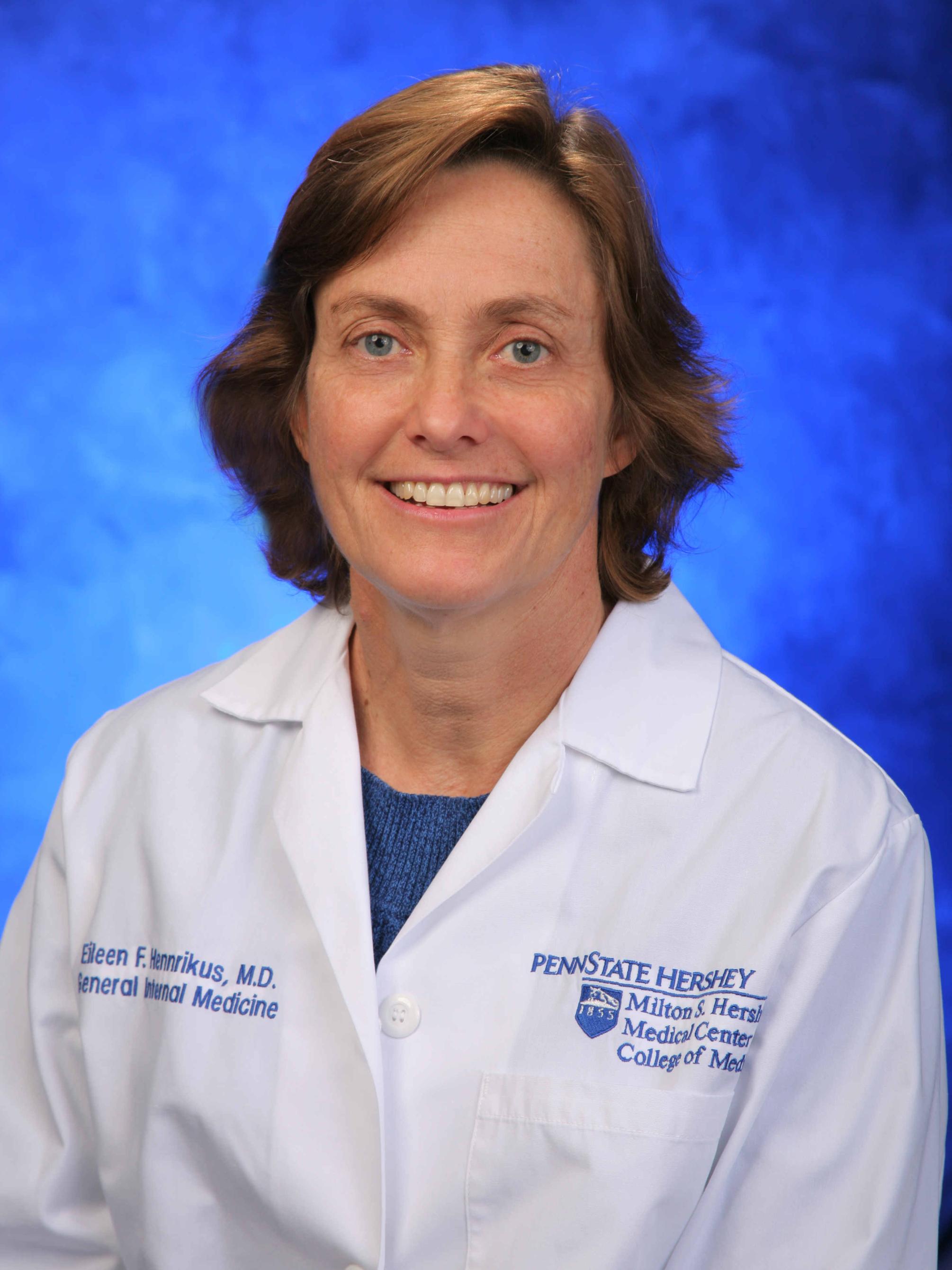 Dr. Eileen Hennrikus poses for a professional photo wearing a physician's coat.