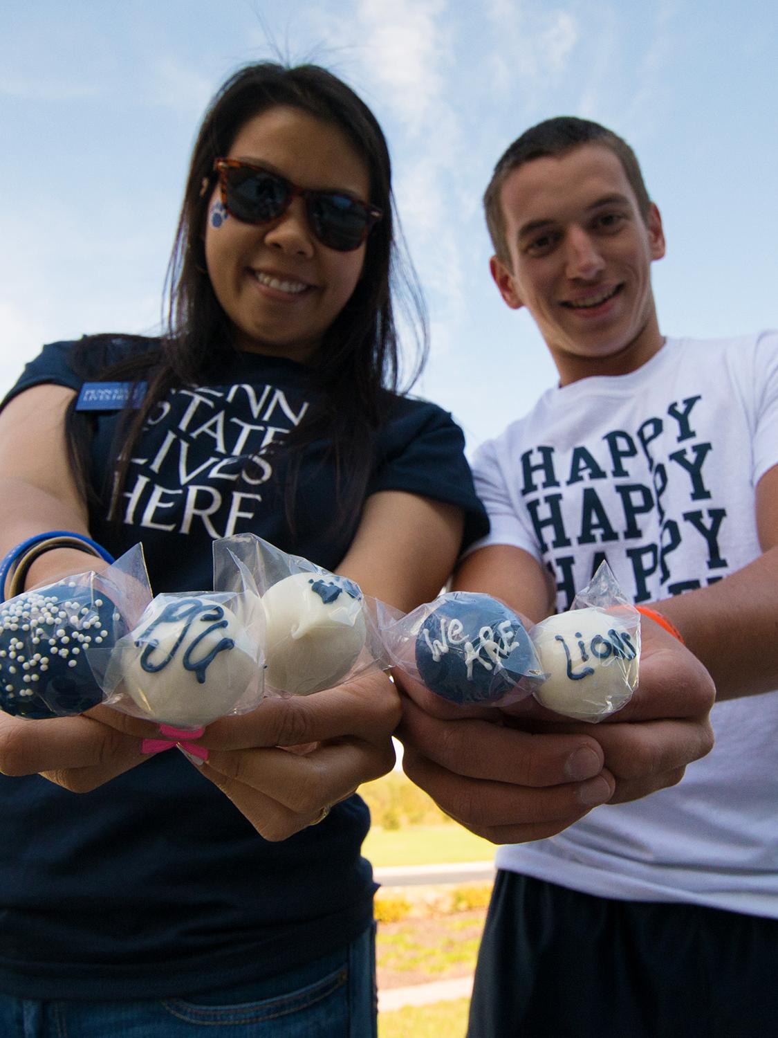students holding lollipops
