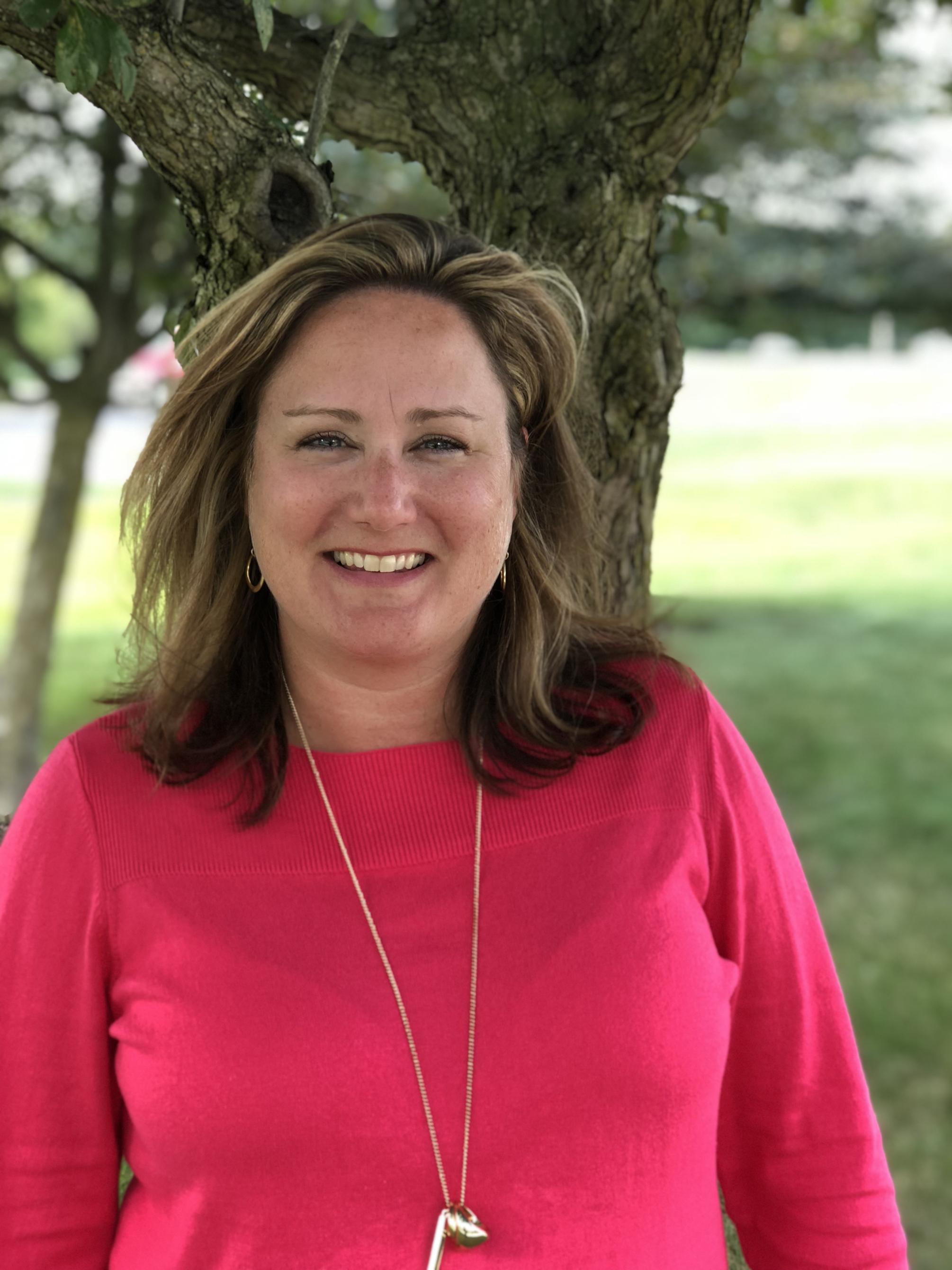 Stephanie Delaney outside near tree. 