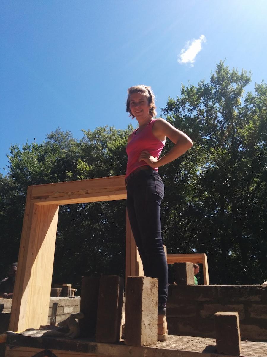 Lily McCullough standing beside a frame that she built