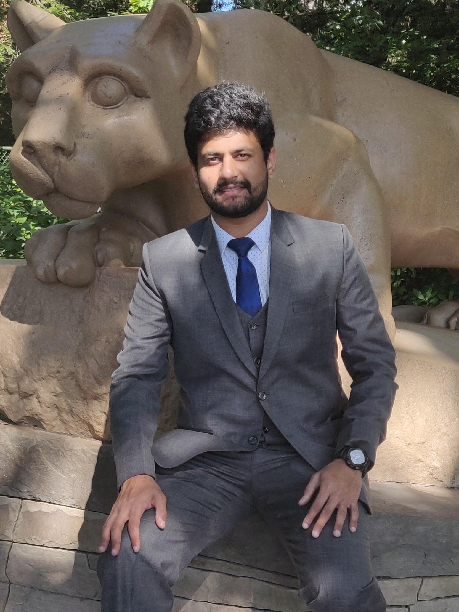 Aaqil Rahman in front of the lion statue