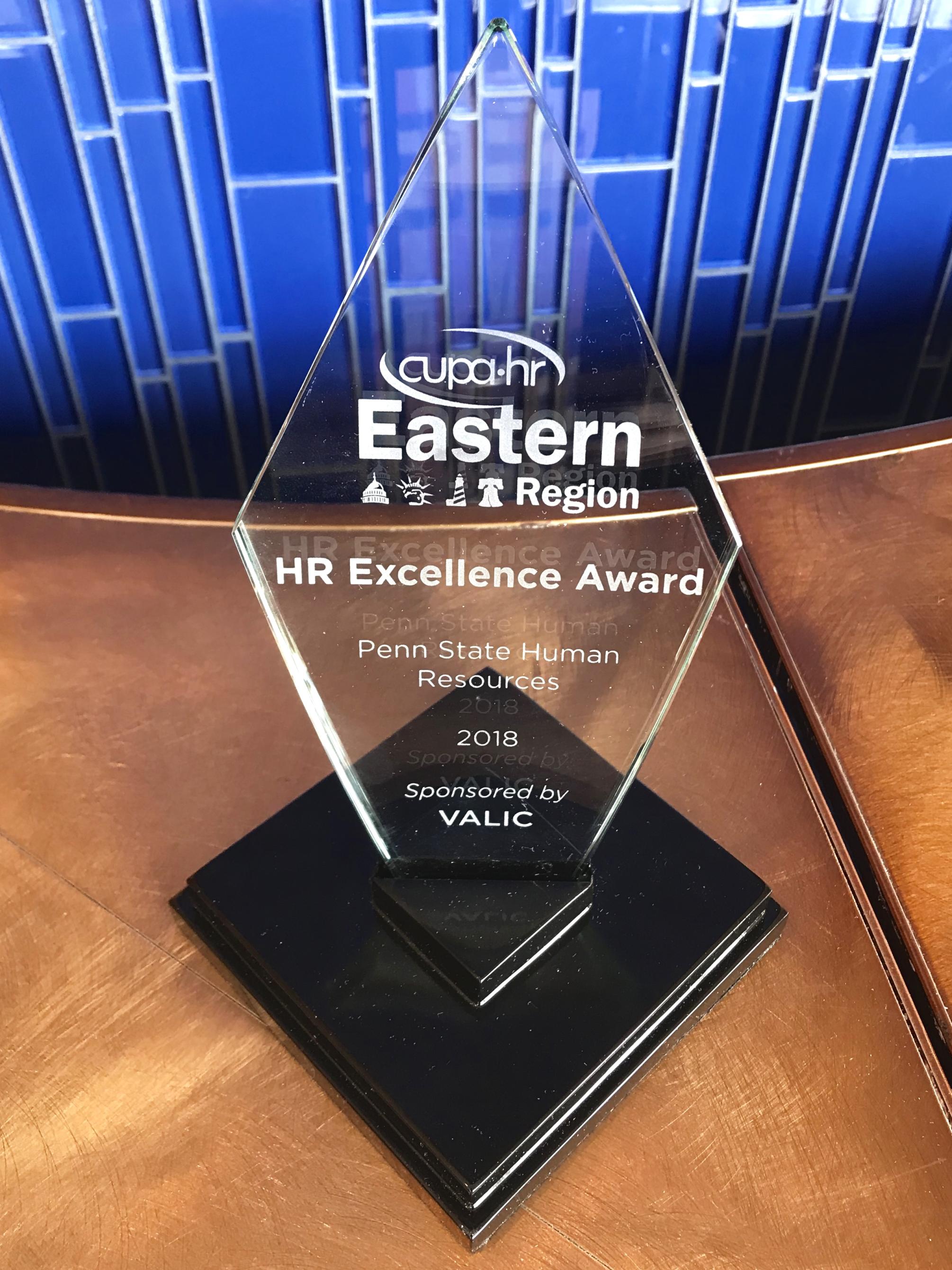 A close up of the HR Excellence Award, presented to Penn State HR.