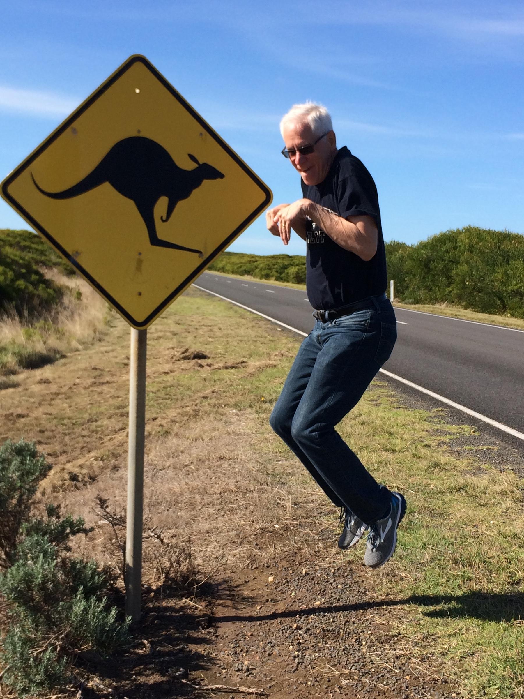 A professor jumps in the air, mimicking a kangaroo. 