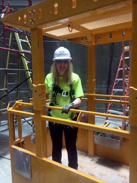 Rockwell standing with a hard hat on