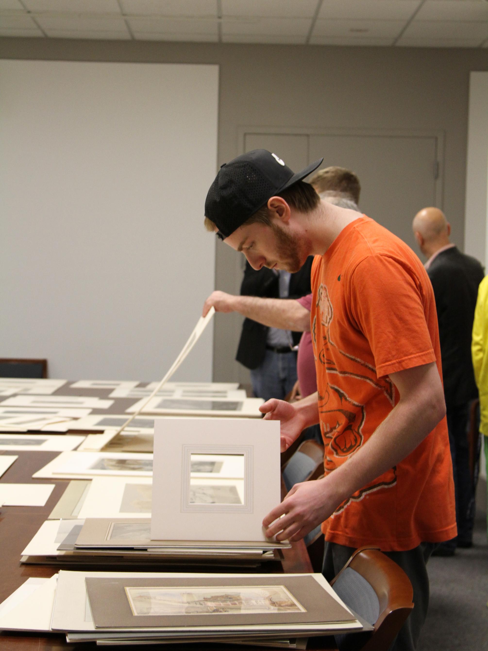 student looking at prints