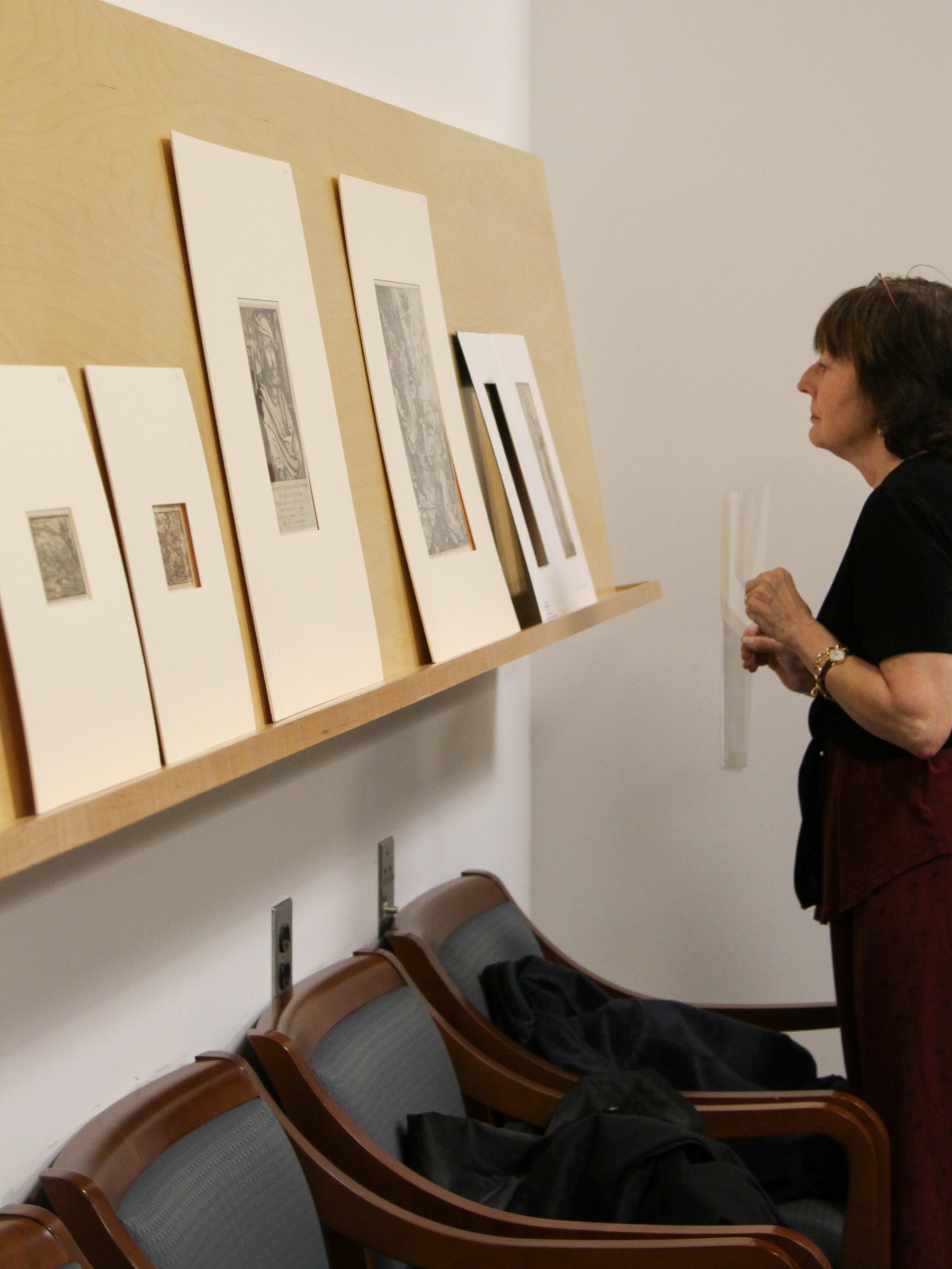 Art history professor, Charlotte Houghton, examining a print 