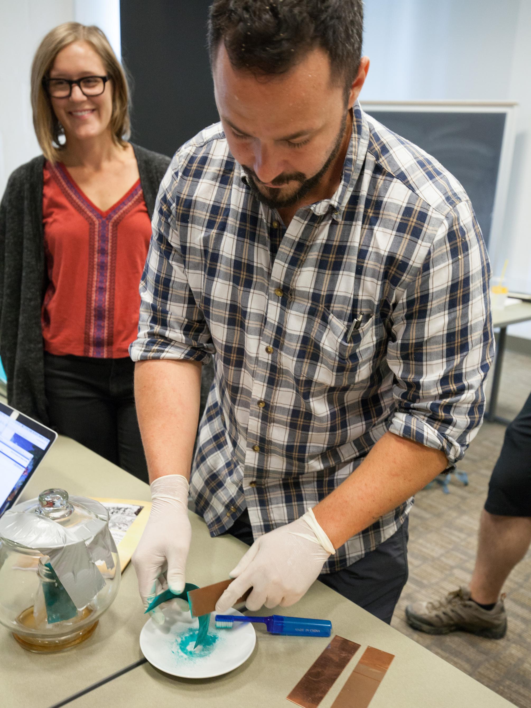 Hillel O'Leary scrapes the patina off of copper to create verdigris. 