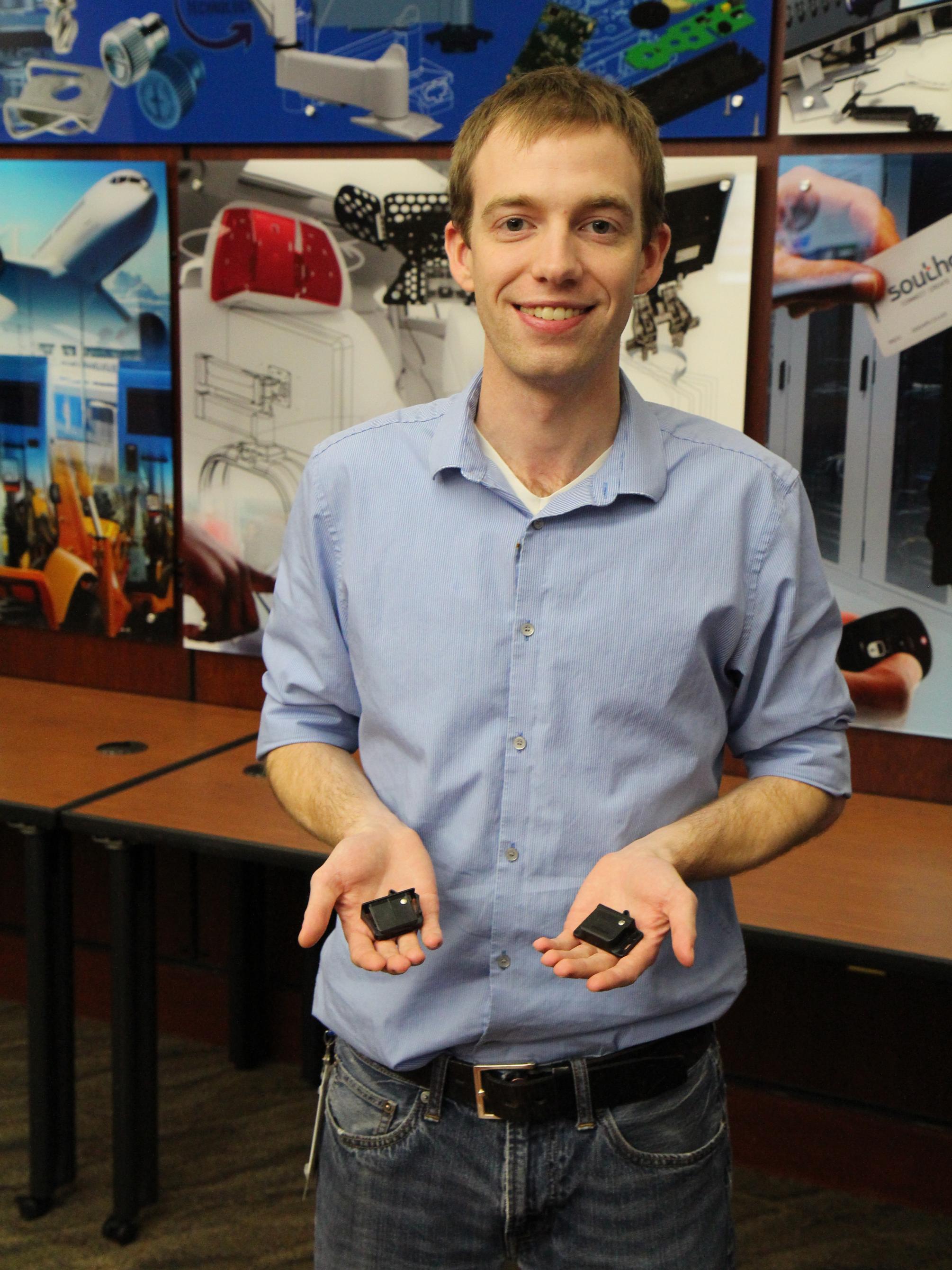 Mitch Engleka showing the C3 latch from his capstone project at Southco