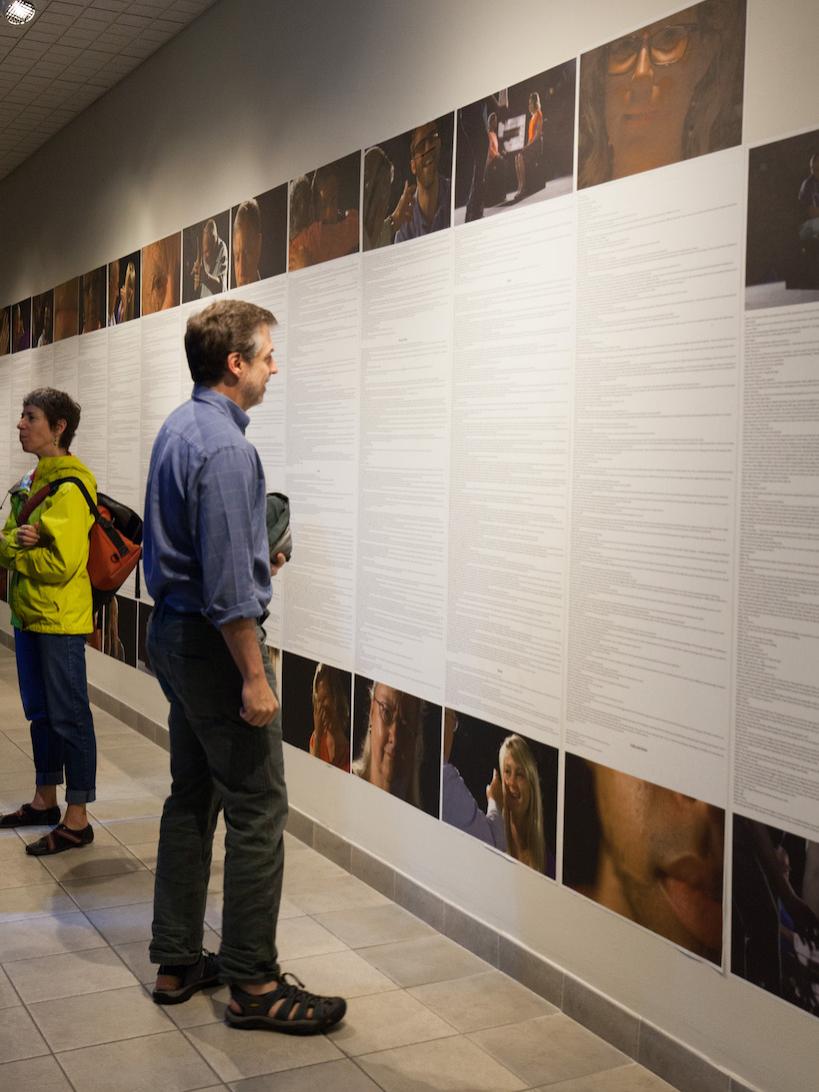 A FaceAge visitor reads the transcript wall. 