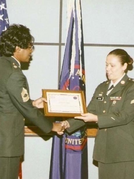 Markey shakes hands with female military member