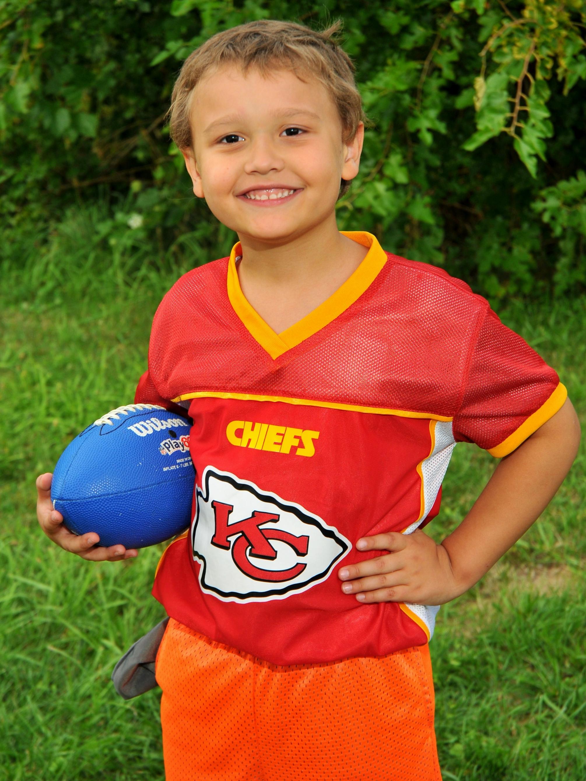 Jakob Cole poses with a football.