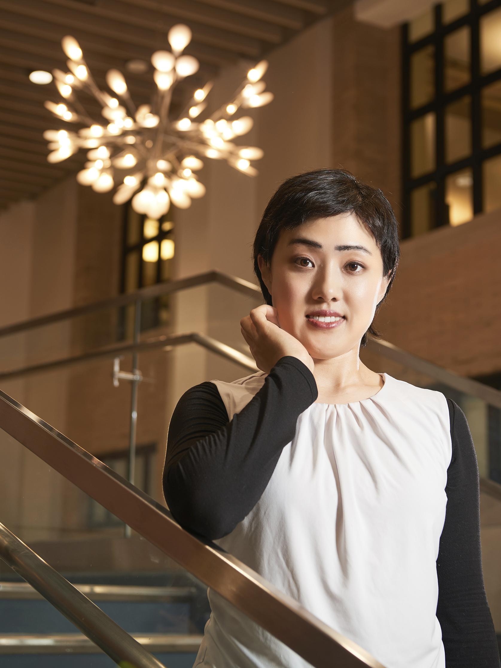 Jessica Ho stands on a staircase