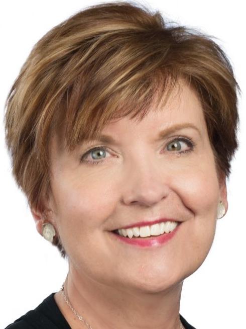 Head shot of a woman smiling with short, brown hair