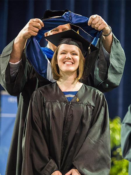 Karen Harlen receiving her master's hood