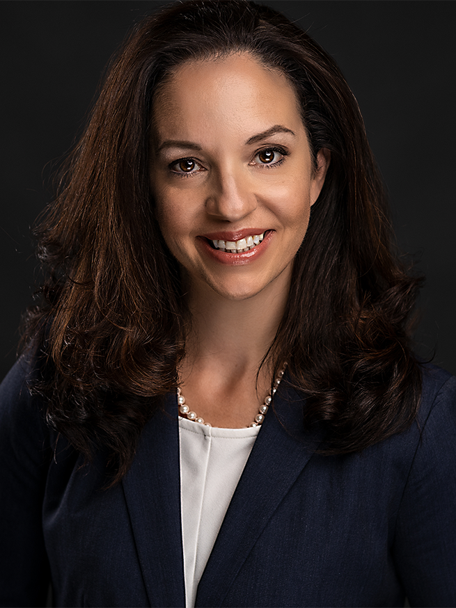 Headshot of Kathleen Fabrizi in a studio on a dark background