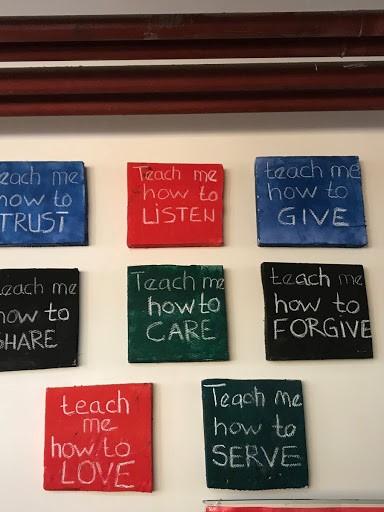 A wall with various "teach me" phrases