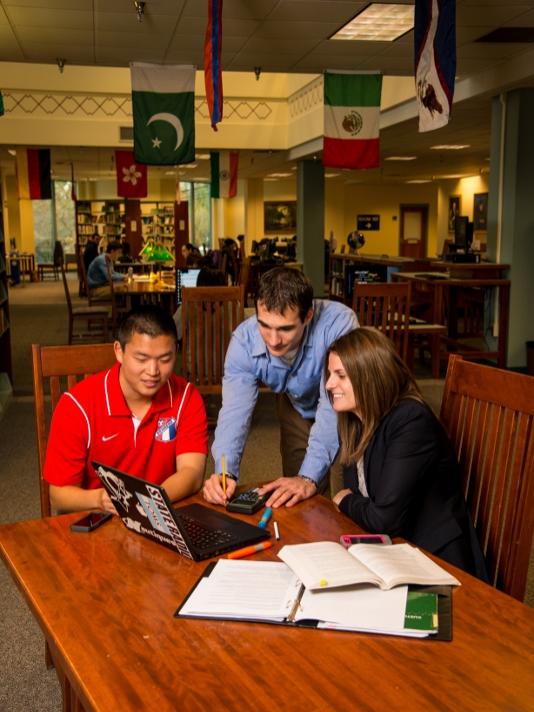 Penn State Behrend MBA students work on a project in Lilley Library.
