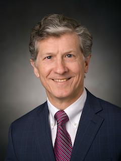 Man poses and smiles for portrait
