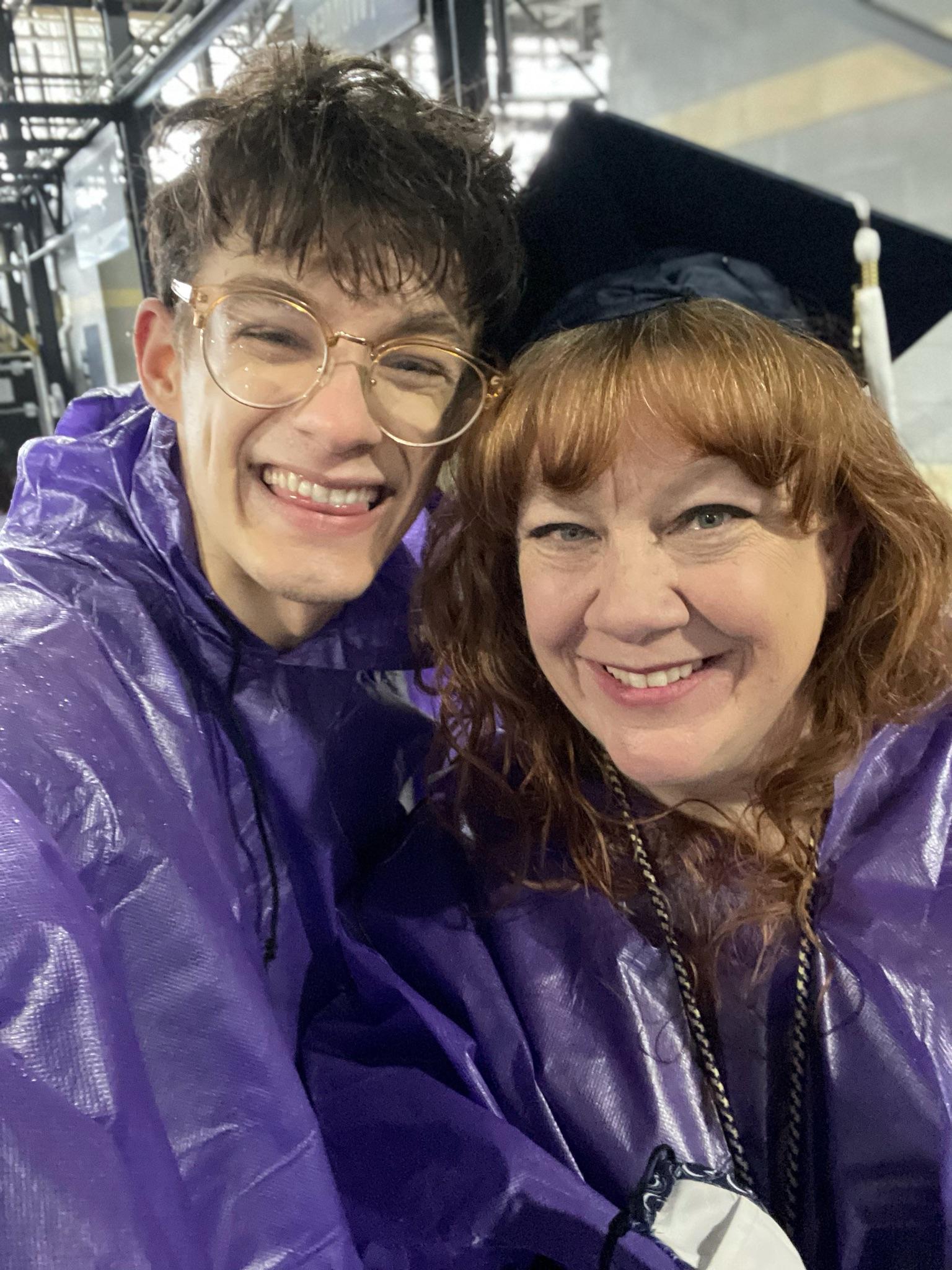 Rebecca Liebman and son Carter wear purple ponchos at commencement.