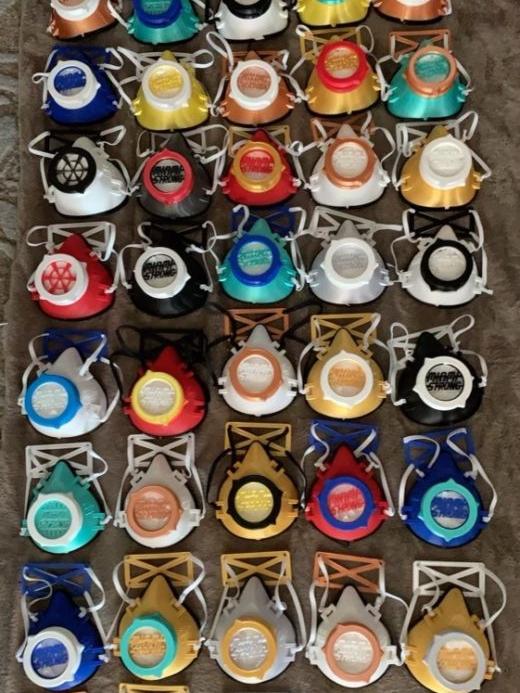 Approximately 40 facemasks of different styles and colors on display.