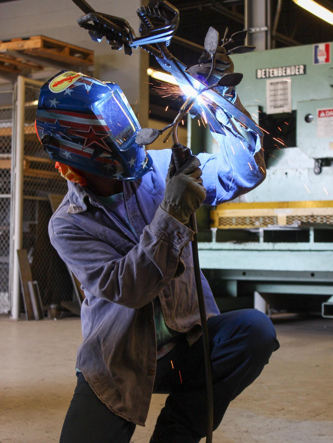 Penn College student welding metal
