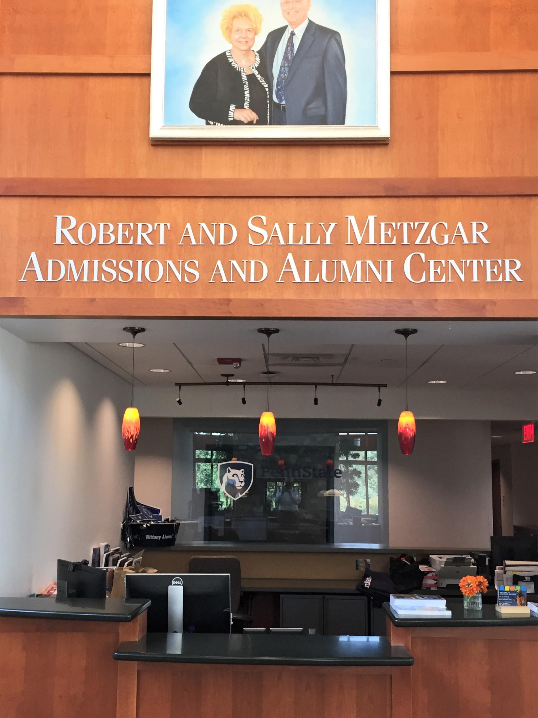 A portrait of Sally and Bob Metzgar, hung above the reception desk at Penn State Behrend's Metzgar Center