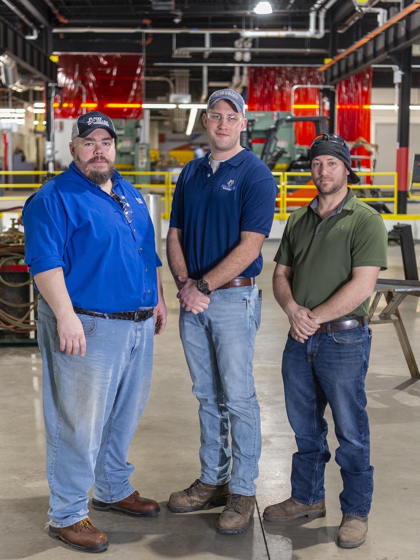 Three men standing next to each other