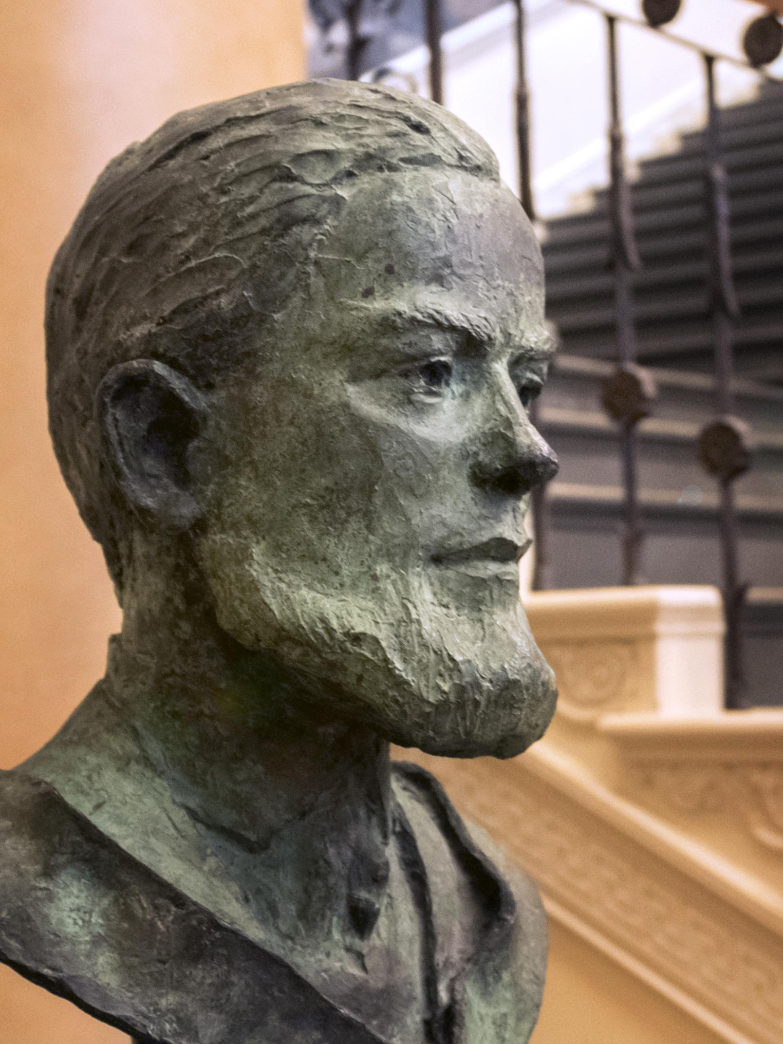 A bust of Evan Pugh near a wide staircase