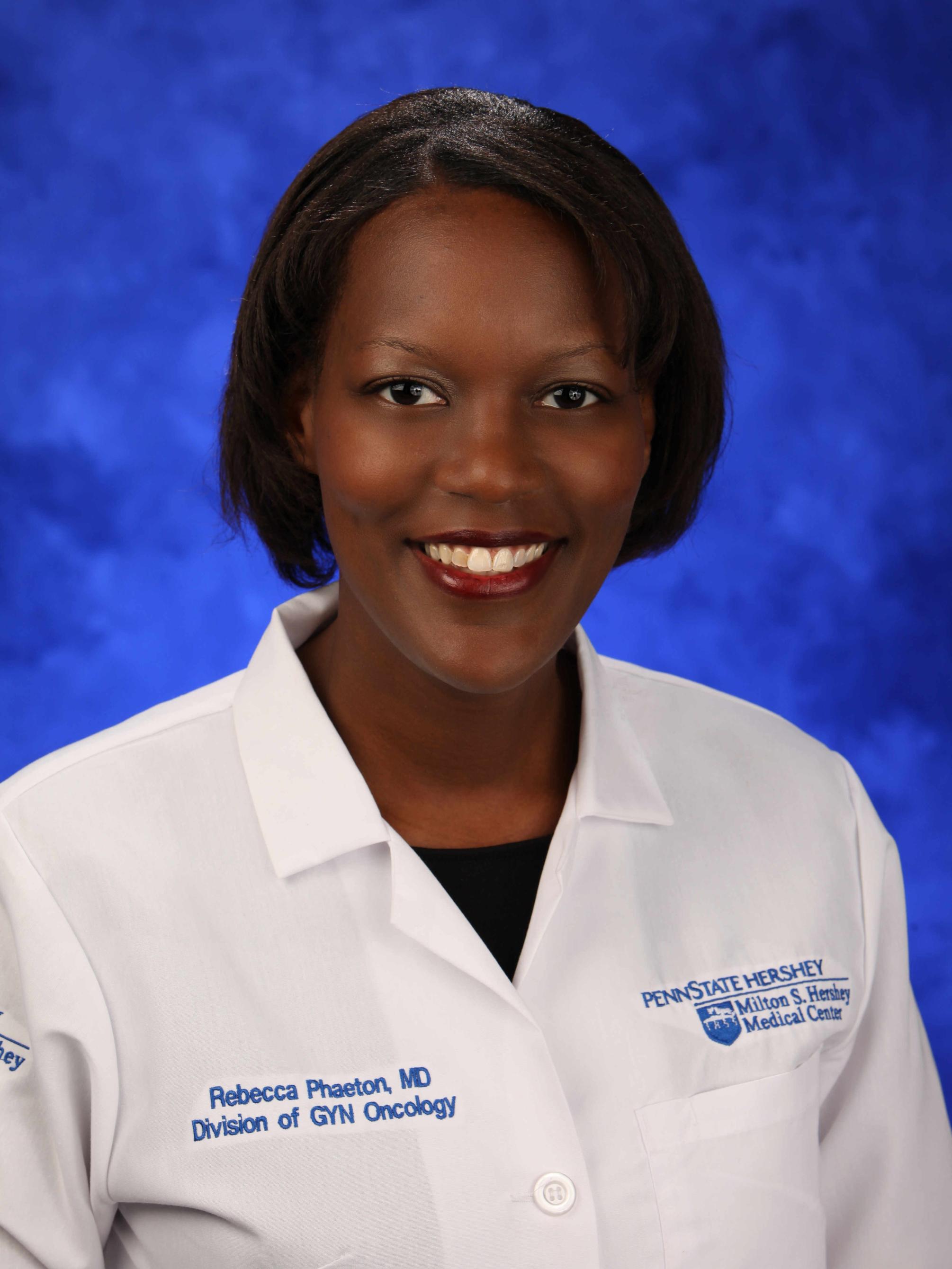 Dr. Rebecca Phaeton poses for a professional headshot wearing her physician coat.