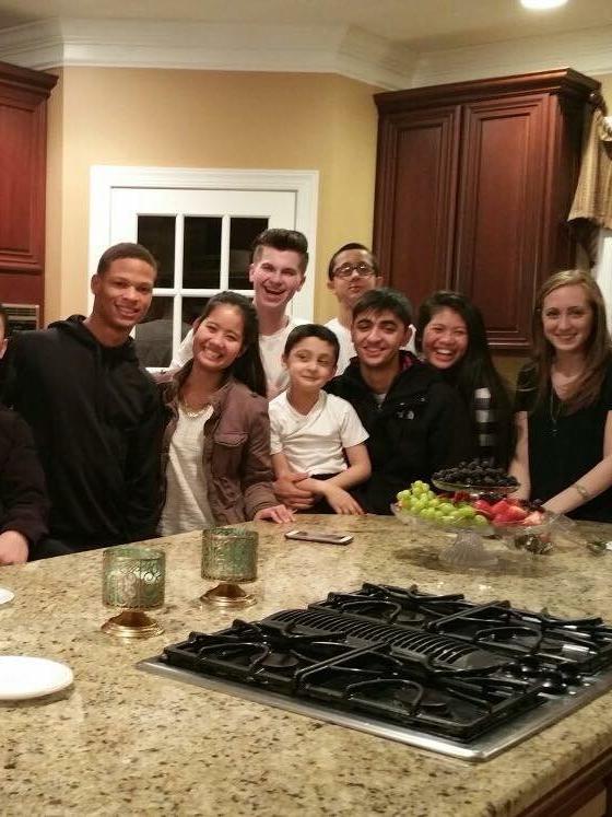 A group of students around a kitchen island