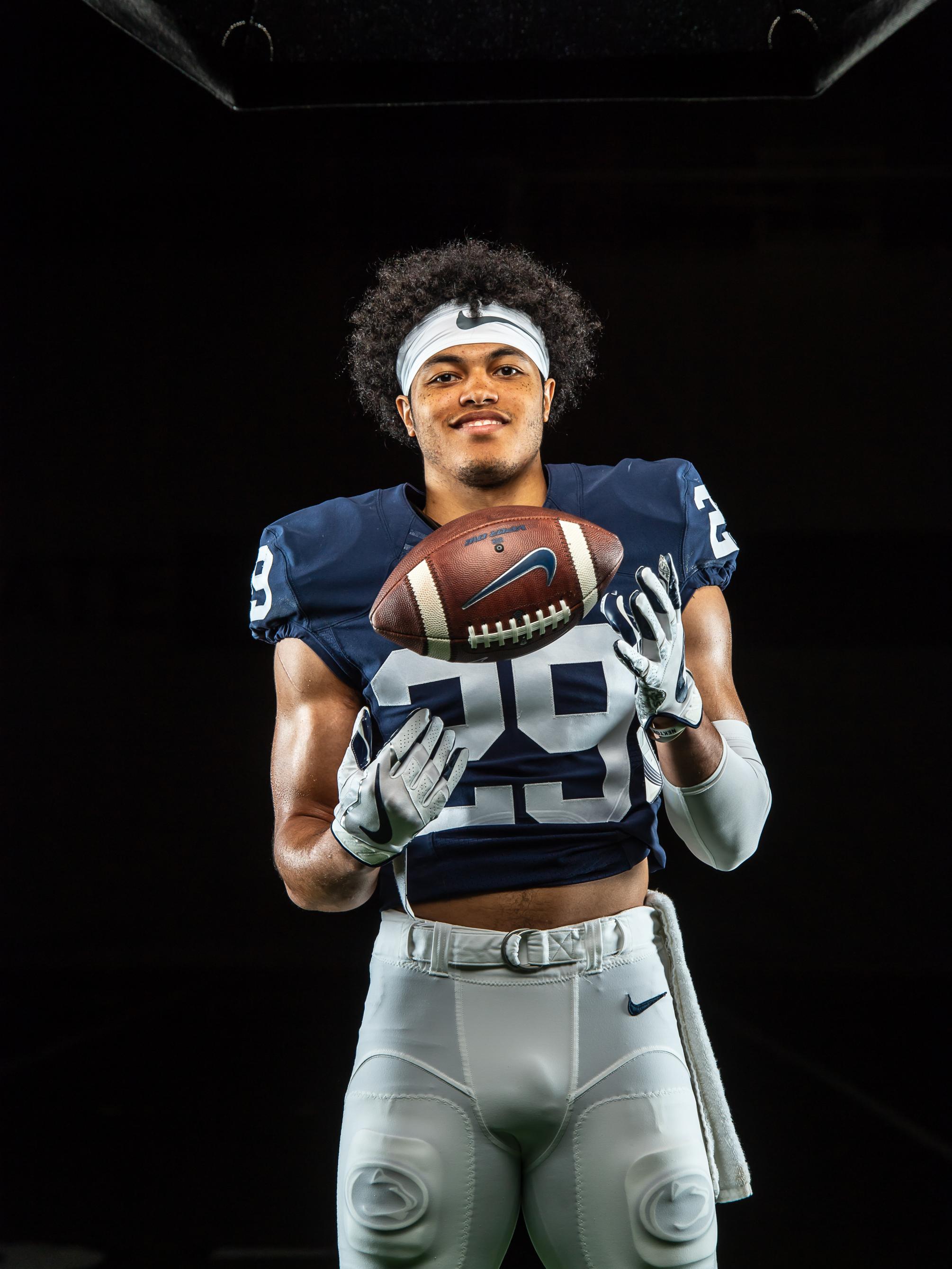 A football player wearing his uniform and holding a football
