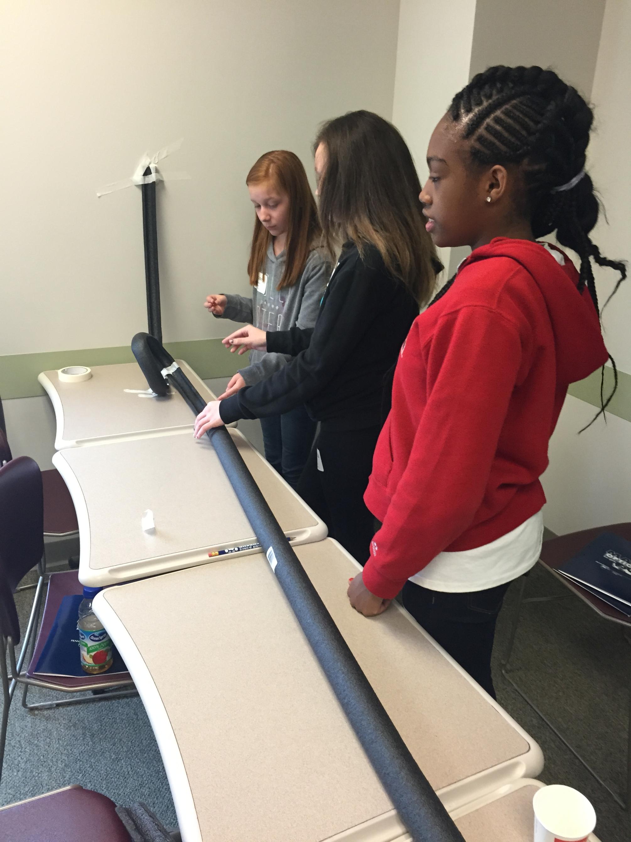 For the Rollercoaster Physics workshop at Math Options Career Day, students were given 20 minutes to create a rollercoaster for a marble to travel on, using only pipe insulators and tape. 