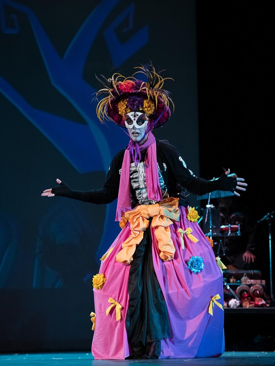 An actor wears a skull-themed costume and dress.