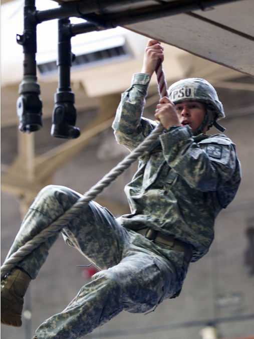 Jake Ahle climbing a rope