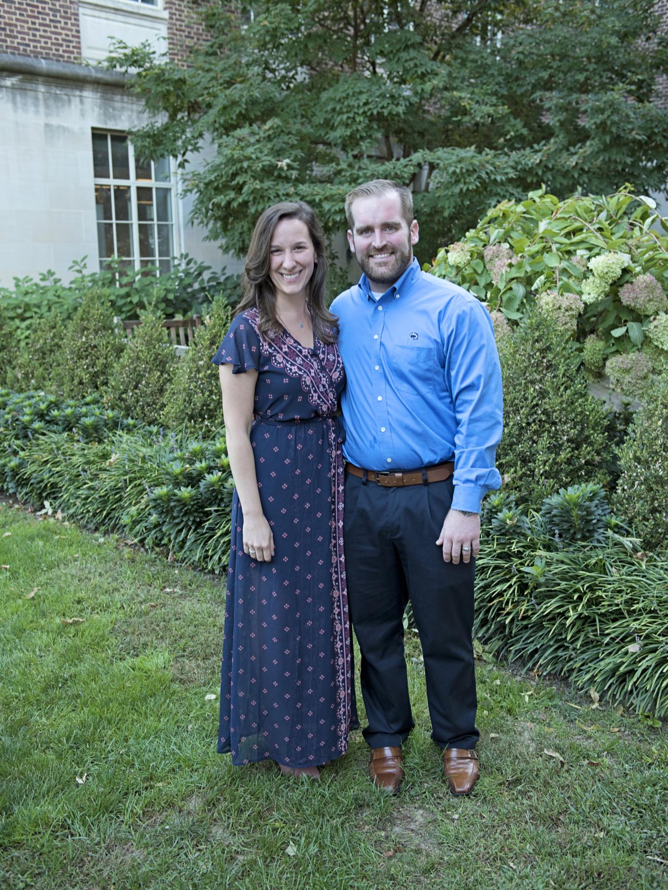 Shane and Mallory Flickinger stand outside Henderson Building next to some bushes