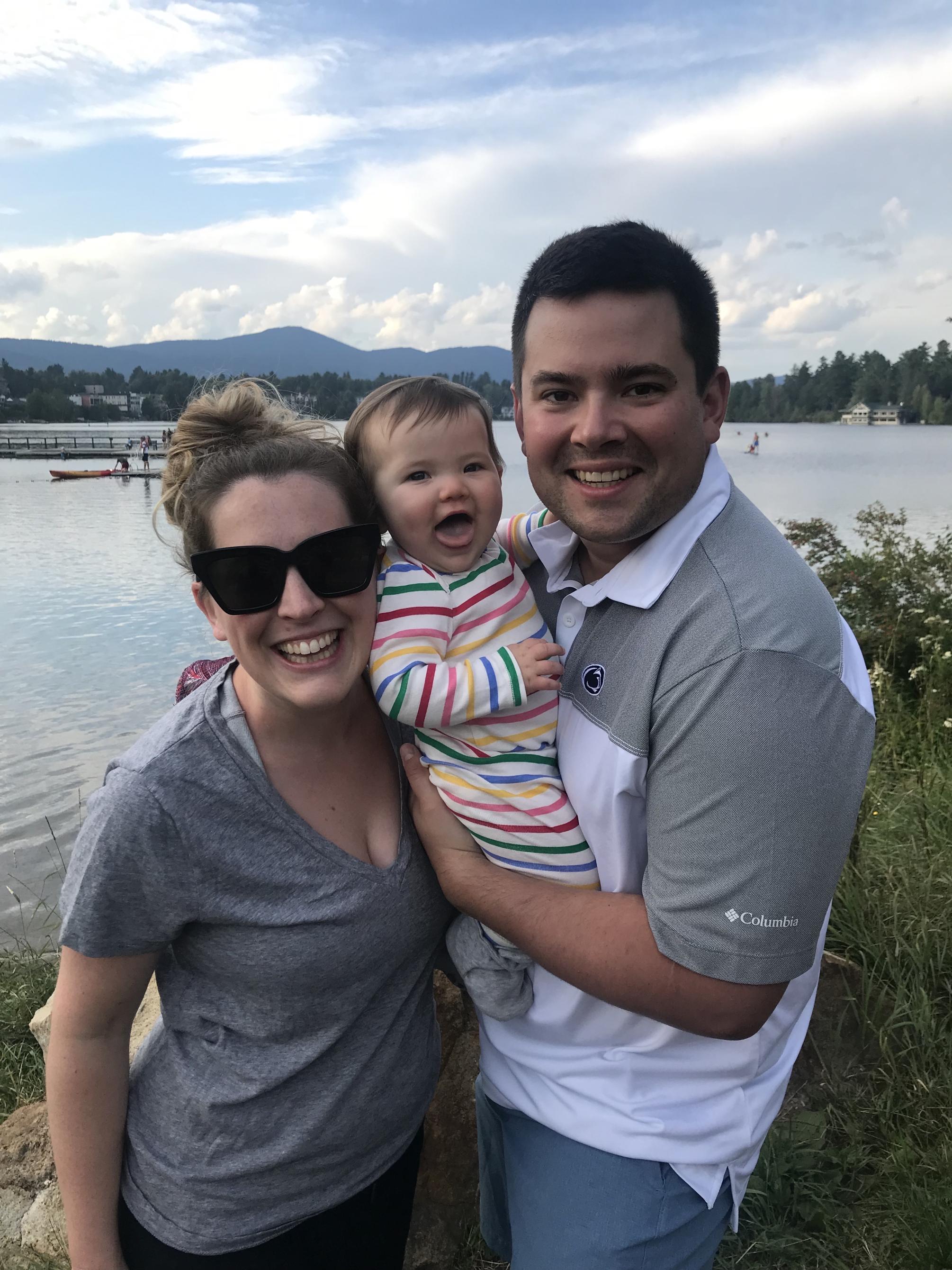 Jeffrey Sharp and his wife and daughter smile at Lake Placid. 