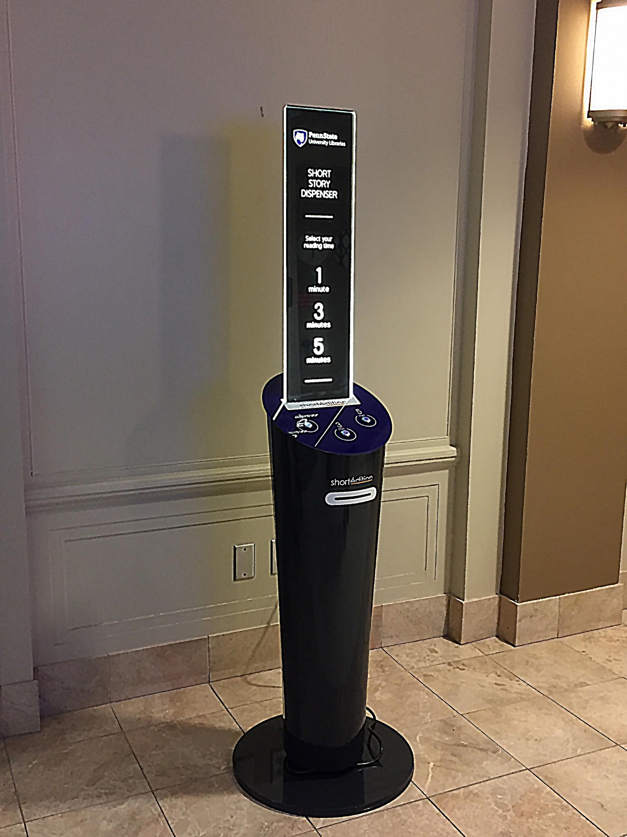blue short story dispenser in hallway in Penn State Pattee Library near main entrance