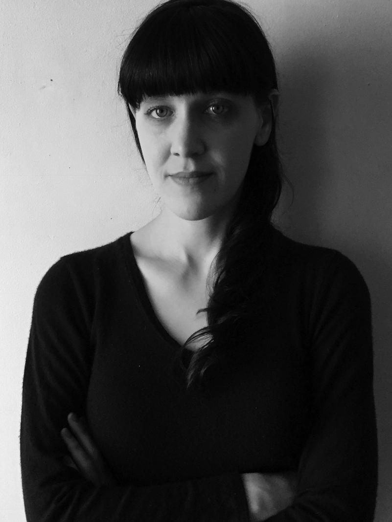 Black and white headshot of Tess Clancy
