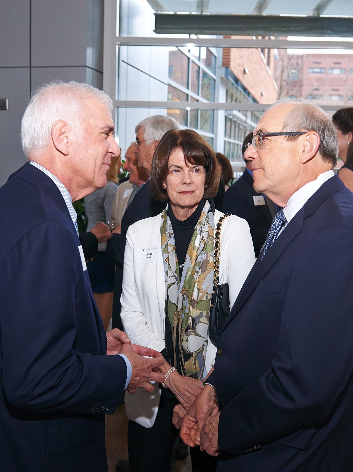 Peter Tombros '64, '68g, talks with the Janiak family at the Leaders Celebration