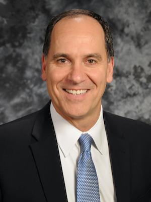 A researcher poses for a professional headshot. 