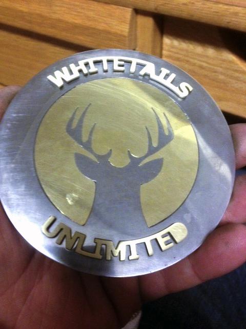 A Whitetails Unlimited belt buckle